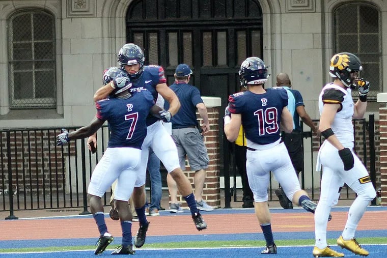 Penn’s Christian Pearson (7) and Justin Watson (5) celebrate a touchdown in the second quarter Saturday, September 16, 2017 at Franklin Field in Philadelphia, Pennsylvania.