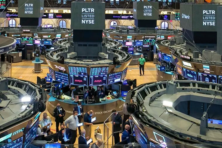 In this photo provided by the New York Stock Exchange, traders gather at a post on the NYSE trading floor during the direct listing of Palantir Technologies, Wednesday, Sept. 30, 2020. Shares of the data-mining company Palantir jumped on their first day of trading. Now a Sunnyvale, Ca. firm is seeking to train underrepresented groups to excel in the world of data, which is growing more essential all the time. (NYSE Photo/Courtney Crow via AP)