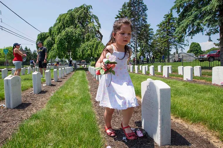 Since 1973, a group has been decorating the graves at the Carlisle Indian Cemetery over Memorial Day Weekend - a vigil of sorts over the decades when others lived too far away and others had just forgotten. Day-own-day Sharp, 5, of Harrisburg looks over the students' graves before they decorated them on May 28, 2016. Day-own-day is of Kiowa and Karuk descent and has been attending this event from infancy.