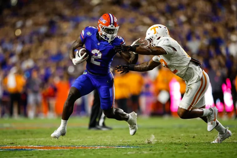 GAINESVILLE, FLORIDA - SEPTEMBER 16: Montrell Johnson Jr. #2 of the Florida Gators runs the ball against Tamarion McDonald #12 of the Tennessee Volunteers during the first half of a game at Ben Hill Griffin Stadium on September 16, 2023 in Gainesville, Florida. (Photo by James Gilbert/Getty Images)