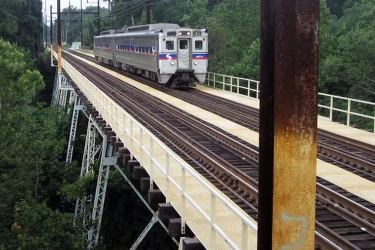 A SEPTA train crosses the Crum Creek rail bridge.