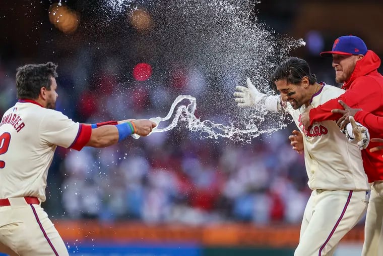 Philadelphia Phillies outfielder Nick Castellanos is doused in water by Philadelphia Phillies designated hitter Kyle Schwarber after his walk-off single to win it for the Phillies in the ninth inning.