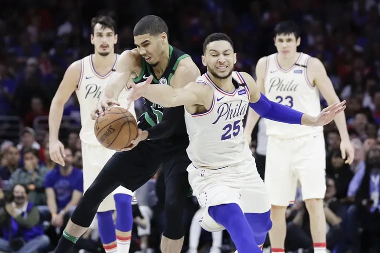 Boston Celtics forward Jayson Tatum grabs the loose basketball past Sixers guard Ben Simmons during the fourth-quarter in game three of the Eastern Conference semifinals on Saturday, May 5, 2018 in Philadelphia.