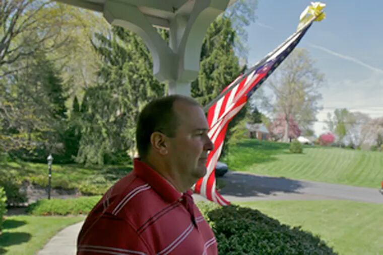 Mark Umbrell, the slain soldier&#0039;s father, stands on the porch of his house. In their last telephone conversation, the two discussed the Eagles&#0039; recent draft choice.