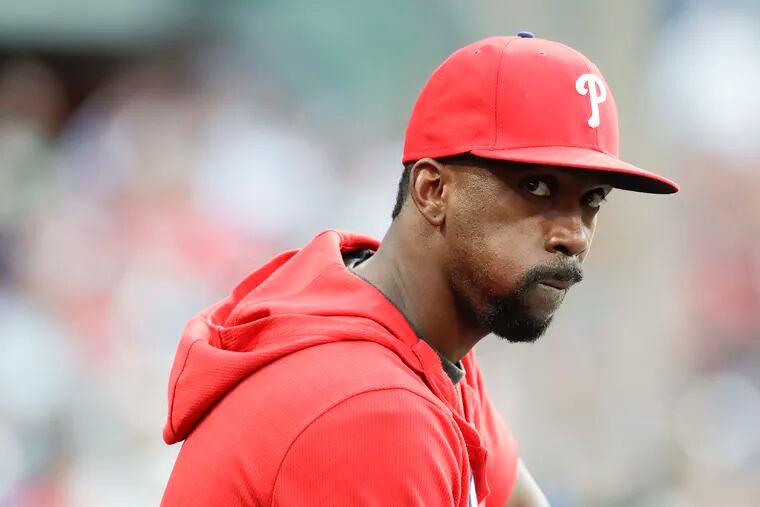 Injured outfielder Andrew McCutchen sits on bench watching the Phillies take on the Washington Nationals on Friday night.