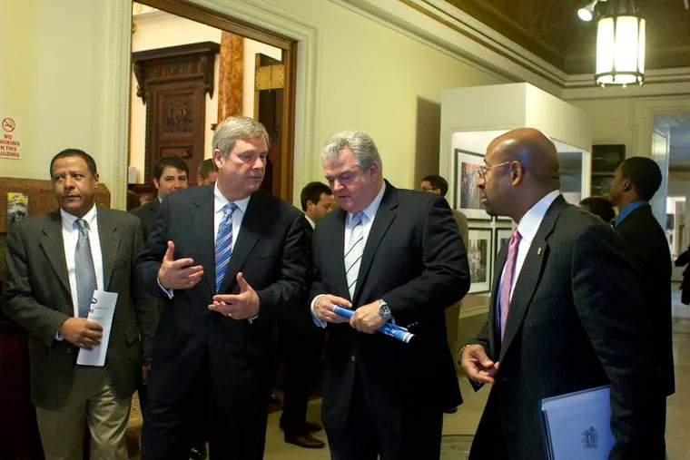 US Secretary of Agriculture, Tom Vilsack, Mayor Michael Nutter and Congressman Bob Brady met at City Hall today where they hosted a round table and then a press conference to talk about the state's proposed asset test for food stamps. IN THIS PHOTO, US Secretary of Agriculture, Tom Vilsack, center left,  Congressman Bob Brady, center  Mayor Michael Nutter converse while shuttling between the round table discussion and their press conference. (Ed Hille / Staff Photographer) Jan 26, 2012 pstamps27 126880