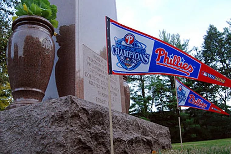 Phillies World Series championship pennants decorate a gravesite in West Laurel Hill Cemetery, Bala Cynwyd, Pa.  (Donald D. Groff / For the Daily News)