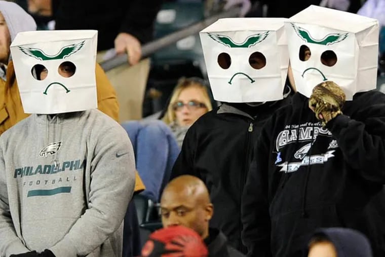 Eagles fans wear paper bags over their heads in the second half of an NFL football game against the Carolina Panthers, Monday, Nov. 26, 2012, in Philadelphia. Carolina won 30-22. (Michael Perez/AP file)