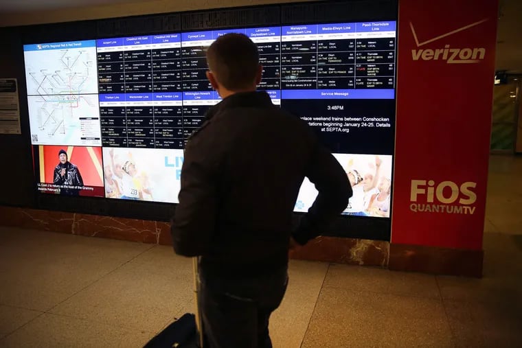 Kevin Cruley of Center City checks a schedule board for Regional Rail passengers at Suburban Station. Two lines will have the biggest changes.