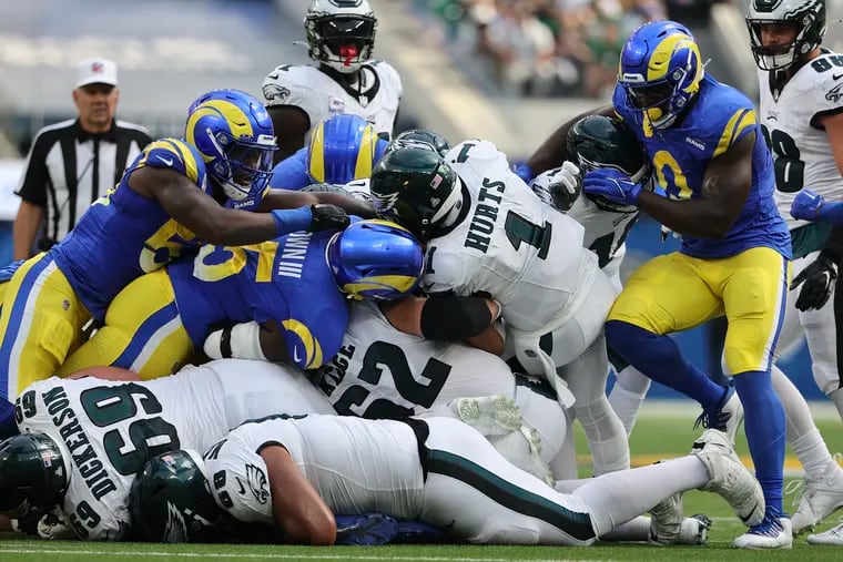 Eagles quarterback Jalen Hurts sneaks for a first down past the Los Angeles Rams defense in the second quarter at SoFi Stadium.