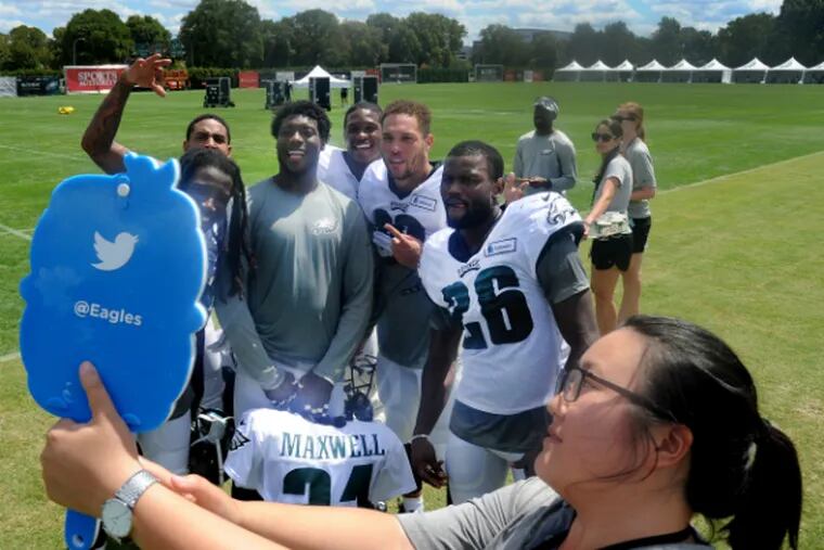 Posing for team staffer Katie Tang are (from left) d-backs E.J. Biggers, Marc Anthony, Byron Maxwell, Eric Rowe, Ed Reynolds, Walter Thurmond.