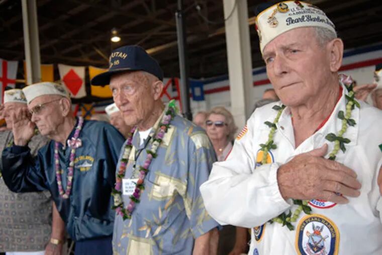 World War II veterans participate in a Pearl Harbor commemoration yesterday at Pearl Harbor, Hawaii, joining other vets in observing the 67th anniversary of the devastating Japanese military raid. Story, Page 12.