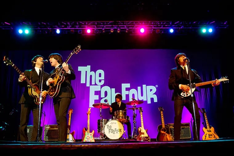 The Fab Four: Paul McCartney (Ardy Sarraf), George Harrison (Gavin Pring), Ringo (Erik Fidel) and John Lennon (Ron McNeill) re-creating the Beatles first performance on the Ed Sullivan Show onstage at the Scottish Rite Theatre in Collingswood, February 9, 2014.  ( DAVID M WARREN / Staff Photographer )