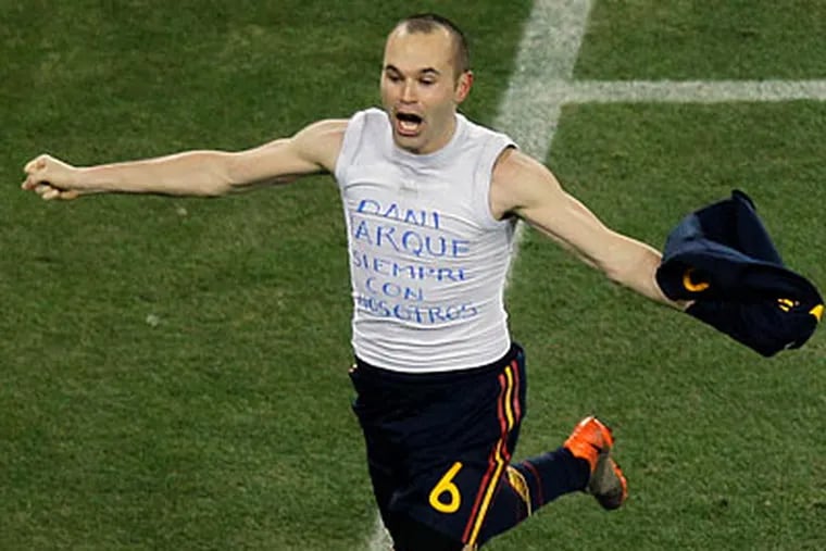 Spain's Andres Iniesta celebrates scoring the winning goal in the World Cup final. (Hassan Ammar/AP)
