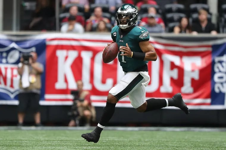 Philadelphia Eagles quarterback Jalen Hurts scramble out of the pocket during the second quarter against the Falcons. Eagles play the Falcons at Mercedes-Benz Stadium in Atlanta, Ga. on Sunday, September 12, 2021. .