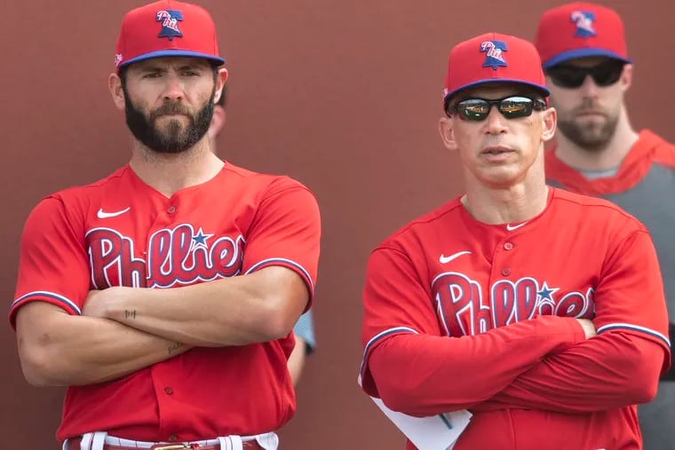 Phillies pitcher Jake Arrieta, left, talks with manager Joe Girardi during a spring-training workout in Clearwater, Fla.