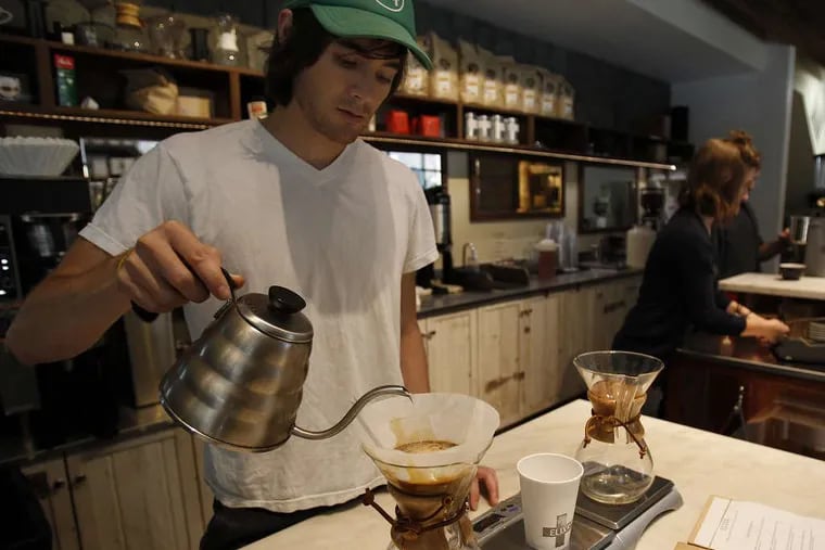 Elixr Coffee founder Evan Inatome prepares a pour-over coffee at an Elixr coffee shop in Philadelphia in 2018.