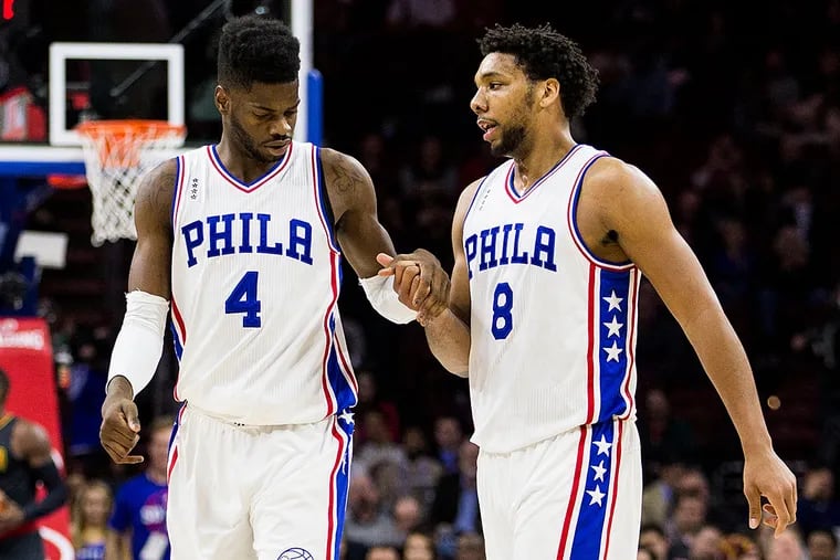 Philadelphia 76ers' Nerlens Noel, left, interacts with Jahlil Okafor, right, during the first half of an NBA basketball game against the Atlanta Hawks, Thursday, Jan. 7, 2016, in Philadelphia. The Hawks won 126-98.