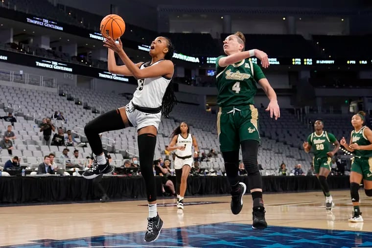 Central Florida guard Diamond Battles, left, goes up for a shot as South Florida guard Elisa Pinzan (4) defends in the first half of an NCAA college basketball game for the American Athletic Conference women's tournament championship Thursday, March 10, 2022, in Fort Worth, Texas.