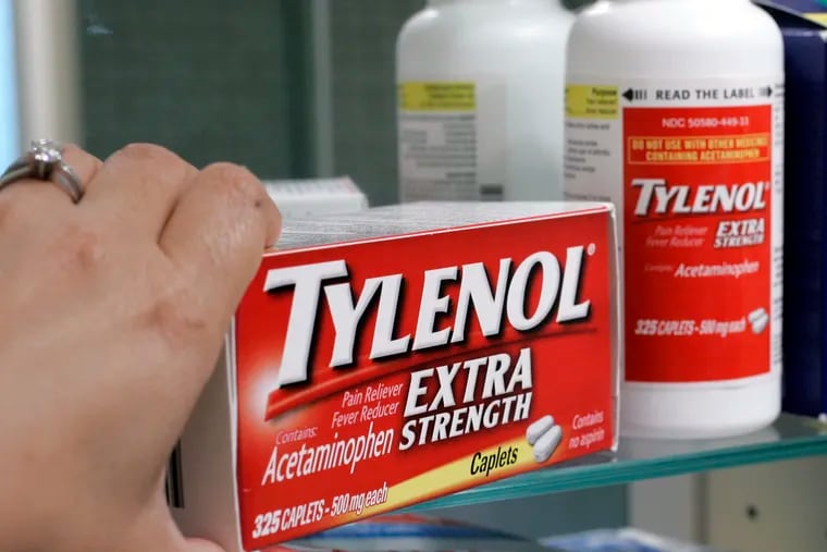 Tylenol Extra Strenth is shown in a medicine cabinet.