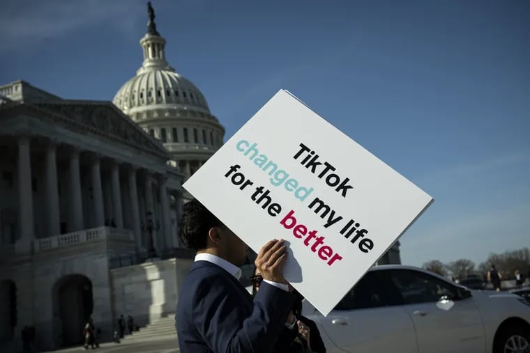 An advocate holds a sign for TikTok following a news conference outside the U.S. Capitol on Tuesday, March 12, 2024.