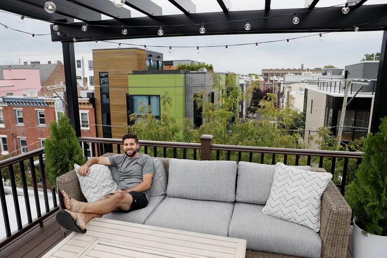 Bill Pilat on his home's new roof deck, which was completed in May, in Southwest Center City. A roof deck is one way for homeowners to increase their property's usable outdoor space.