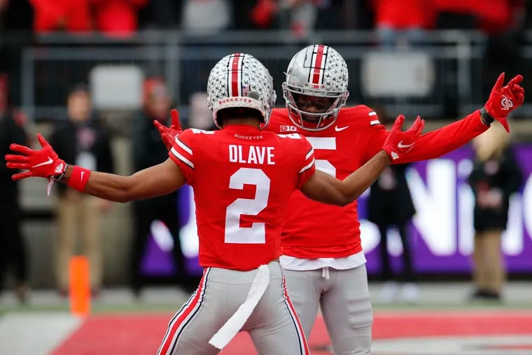 Ohio State receiver Garrett Wilson, right, celebrates his touchdown against Michigan State with teammate Chris Olave during the first half of an NCAA college football game Saturday, Nov. 20, 2021, in Columbus, Ohio. (AP Photo/Jay LaPrete)