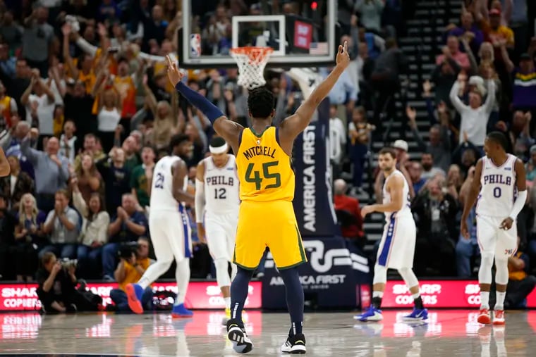 Utah Jazz guard Donovan Mitchell celebrates after a teammate scored against the 76ers during the second half.