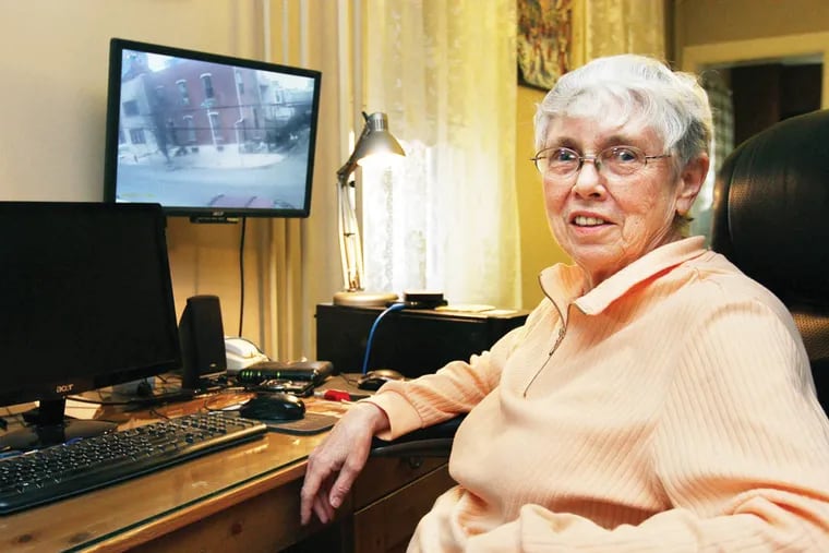 Mary  Dankanis shows off her residential surveillance-camera system in her home in Philadelphia on December 22, 2014.  ( DAVID MAIALETTI / Staff Photographer )