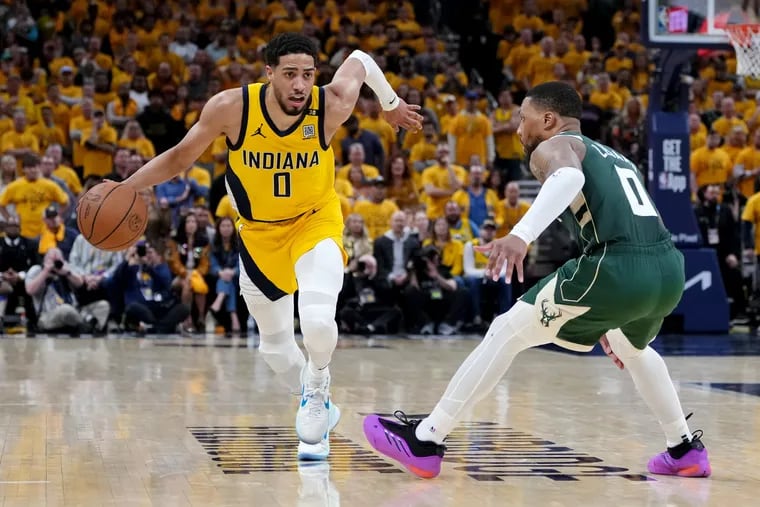 Tyrese Haliburton #0 of the Indiana Pacers dribbles the ball while being guarded by Damian Lillard #0 of the Milwaukee Bucks in overtime during game three of the Eastern Conference First Round Playoffs at Gainbridge Fieldhouse on April 26, 2024 in Indianapolis, Indiana.