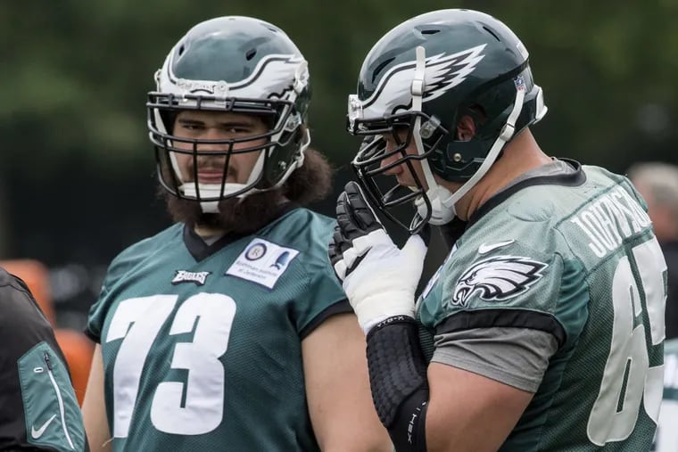 Eagles offensive linemen Isaac Seumalo (left) and tackle Lane Johnson wait for their turn doing a drill during workouts on May 23, 2017.  Coach Doug Pederson told the media that Seumalo is penciled in at the starting left guard in place of the injured Allen Barbre.