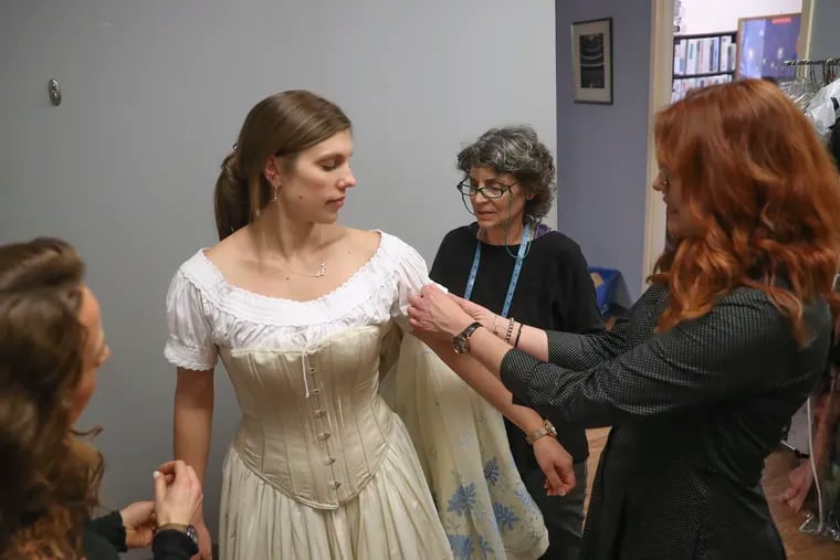 Kara Goodrich, who is playing Mimì, has one of her costumes for the forthcoming production of "La bohème" fitted by Millie Hiibel, Opera Philadelphia's costume director.