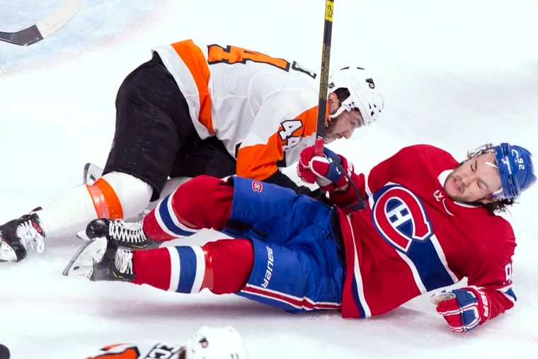 Montreal Canadiens' Jonathan Drouin (92) and Philadelphia Flyers' Phil Varone fall during the first period of an NHL hockey game Thursday, Feb. 21, 2019, in Montreal. (Paul Chiasson/The Canadian Press via AP)