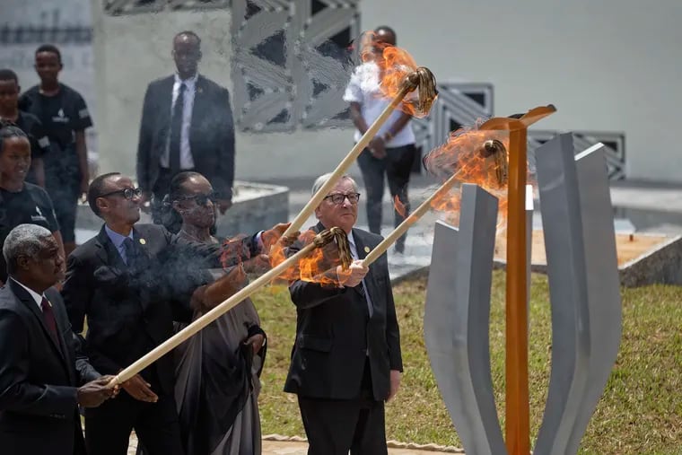 From left to right, Chairperson of the African Union Commission Moussa Faki Mahamat, Rwanda's President Paul Kagame, Rwanda's First Lady Jeannette Kagame, and President of the European Commission Jean-Claude Juncker, light the flame of remembrance at the Kigali Genocide Memorial in Kigali, Rwanda, Sunday, April 7, 2019.  Rwanda is commemorating the 25th anniversary of when the country descended into an orgy of violence in which some 800,000 Tutsis and moderate Hutus were massacred by the majority Hutu population over a 100-day period in what was the worst genocide in recent history. (AP Photo/Ben Curtis)