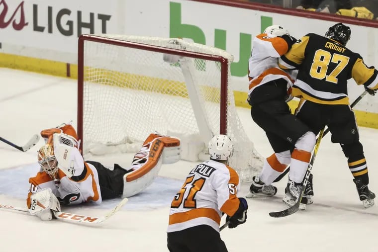 Goalie Michal Neuvirth makes a glove save against Pittsburgh’s  Sidney Crosby with 50 seconds left in Game 5 and the Flyers leading, 3-2. They won, 4-2.