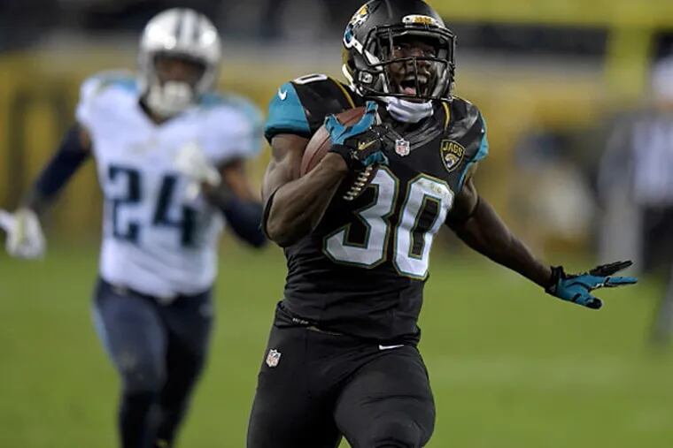 Jacksonville Jaguars running back Jordan Todman (30) is pursued by Tennessee Titans cornerback Coty Sensabaugh (24) on a 62-yard touchdown run in the fourth quarter at EverBank Field. (Kirby Lee/USA TODAY Sports)