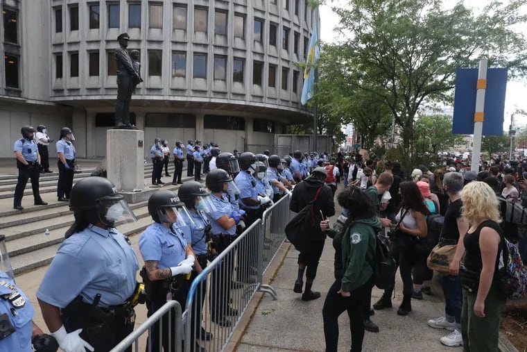 Protesters and police at Police Headquarters on Race Street in Philadelphia on Sunday.