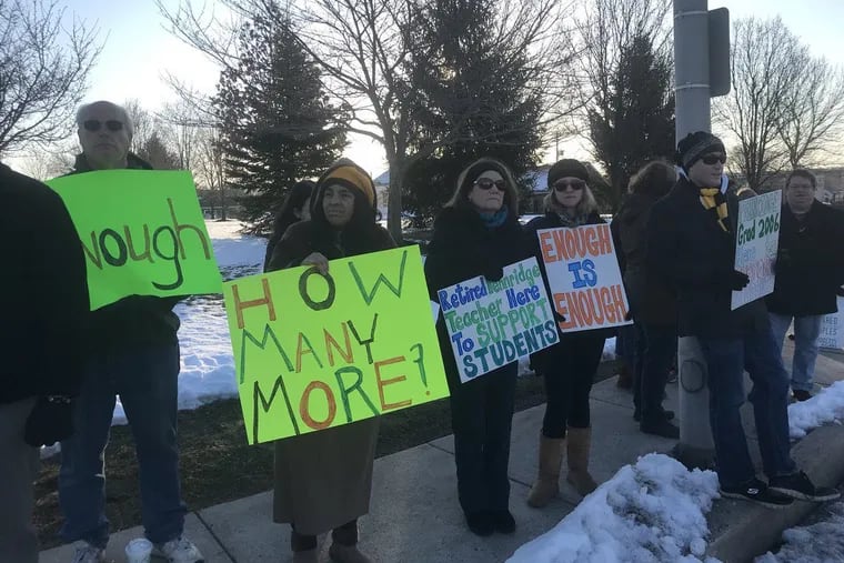 About two dozen protesters Saturday show support outside Pennridge High School in Perkasie for kids forced to serve detention for taking part in National School Walkout Day on March 14.