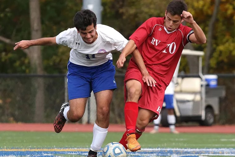 Washington Township's George Charalabidis and Rancocas Valley's Luis Rivadeneira (right) chase after a ball.