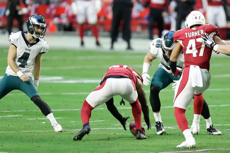 Arizona Cardinals cornerback Patrick Peterson attempts to pick up the football on a bad snap that got away from the Eagles' Zach Ertz  on an extra point try. The regular holder, punter Cameron Johnston, left the game with a head injury.