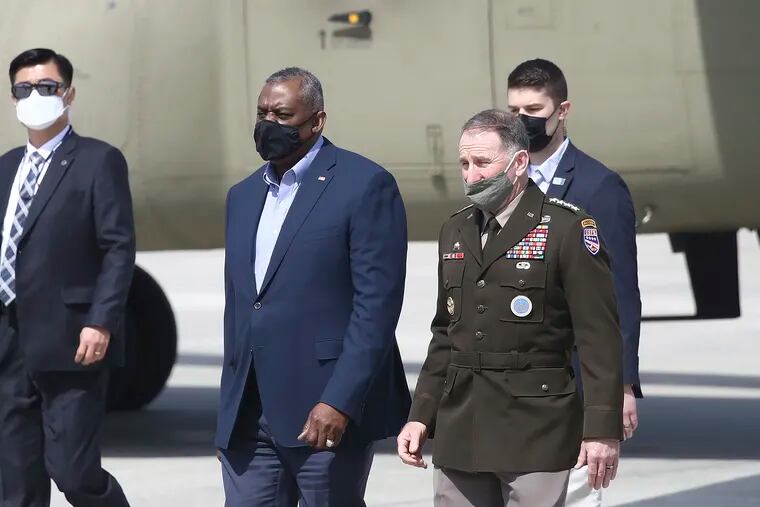 U.S. Secretary of Defense Lloyd Austin, center left, has called for a reexamination of the records of service members who were discharged or denied reenlistment because of gender identity issues under the previous policy.