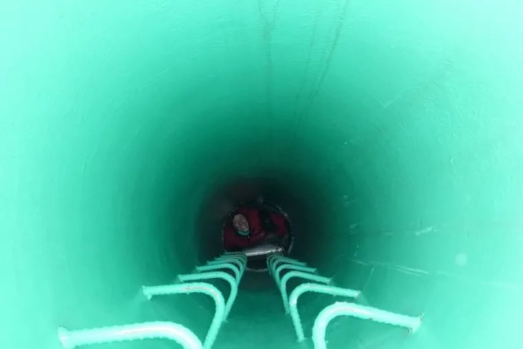 Rutgers scientist Juliane Gross climbs down an observation tube through the Antaractic ice shelf.