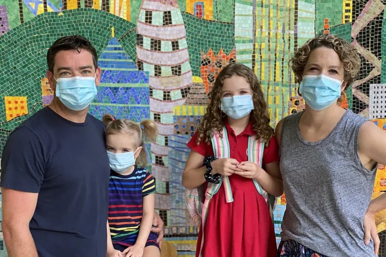 Tanya Underwood and her family standing in front of her daughter's school in Hong Kong.