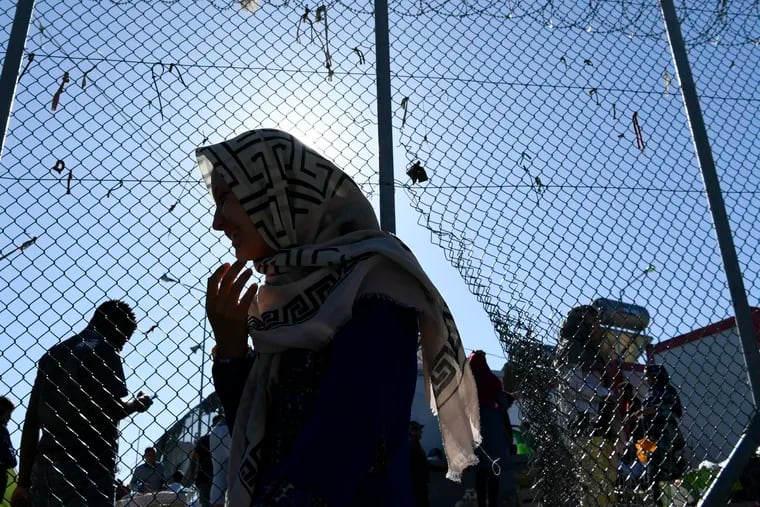 A migrant walks outside the Moria refugee camp, located on the northeastern Aegean island of Lesbos, Greece, earlier this week. Security and municipal services on the Greek island of Lesbos were to hold an emergency meeting after administrators of a refugee camp said they were overwhelmed by the number of arrivals from nearby Turkey.