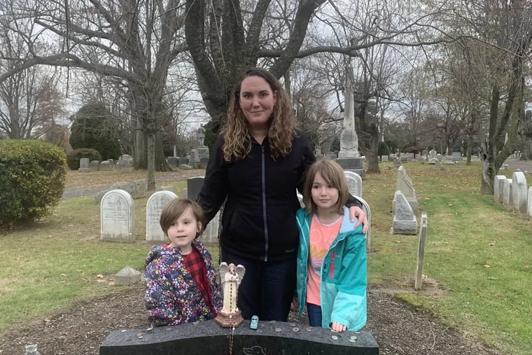 Forensic genealogist Misty Gillis, who put a name to America's "Boy in the Box," with her two youngest children, ages 5 and 7, at the grave of Joseph Augustus Zarelli.