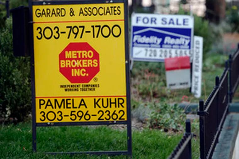 For-sale signs outside homes in Denver. The current credit crunch has been cited as a major reason for sliding sales.