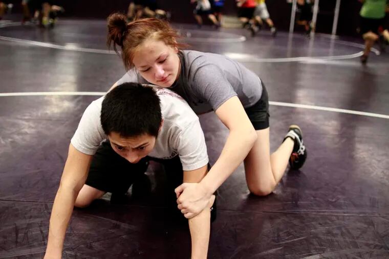 Joelle Simms at CH West wrestles with David Ly.  DAVID SWANSON / Staff Photographer EDITORS NOTE: January 9, 2012, Cherry Hill West, Cherry Hill, N.J. JGMAT14 Feature on girl wrestlers Joelle Simms at CH West. Reporter is Chris Melchiorre.