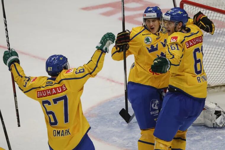 From left, Sweden's Linus Omark, Oskar Lindblom and Johan Ryno celebrate after scoring their team's first goal during the Ice Hockey Channel One Cup match between Sweden and Russia in Moscow, Russia, Thursday, Dec. 15, 2016. Lindblom, who signed an entry-level contract with the Flyers in May, could be one of the new additions to the roster come October.