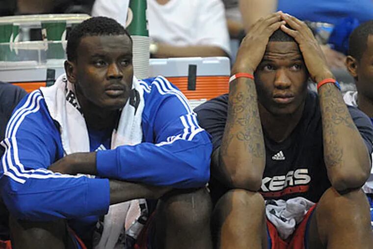 Samuel Dalembert and Marreese Speights couldn't hide during the final seconds of the Sixers' loss. (Phelan M. Ebenhack/AP)
