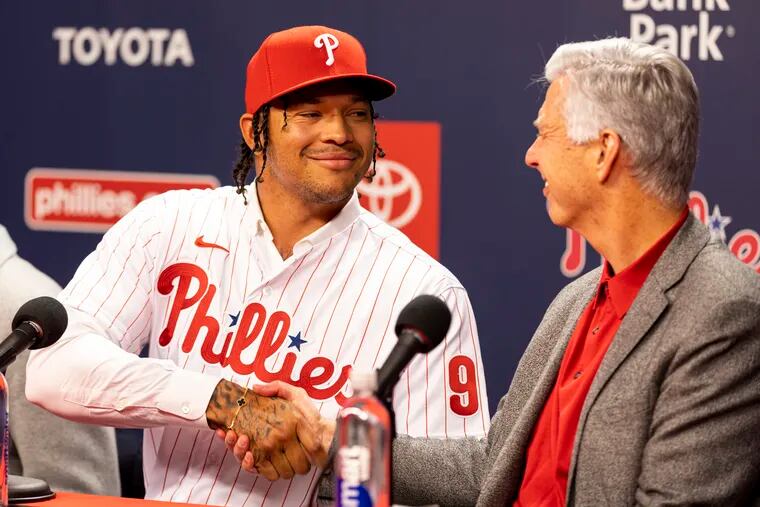 Taijuan Walker (99), shakes hands with David Dombrowski during a news conference at the Citizens Bank Park on Friday.